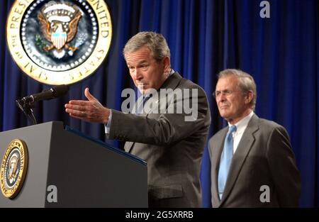 Arlington, United States Of America. 05th Oct, 2001. United States President George W. Bush makes remarks prior to signing H.R. 1588, the National Defense Authorization Act of Fiscal Year 2004 at the Pentagon in Arlington, Virginia on November 24, 2003. United States Secretary of Defense Donald Rumsfeld looks on from right.Credit: Ron Sachs/CNP/Sipa USA Credit: Sipa USA/Alamy Live News Stock Photo