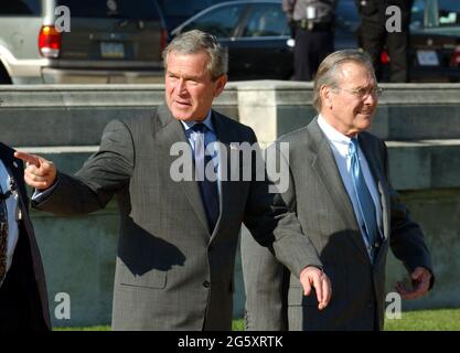 Arlington, United States Of America. 05th Oct, 2001. United States President George W. Bush is escorted to Marine One by United States Secretary of Defense Donald Rumsfeld as he departs the Pentagon in Arlington, Virginia on November 24, 2003 following his signing H.R. 1588, the National Defense Authorization Act of Fiscal Year 2004.Credit: Ron Sachs/CNP/Sipa USA Credit: Sipa USA/Alamy Live News Stock Photo