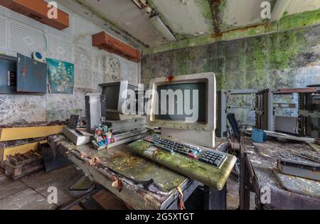 Old computers from the 80s in an abandoned computing center Stock Photo