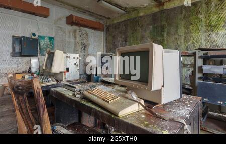 Old computers from the 80s in an abandoned computing center Stock Photo