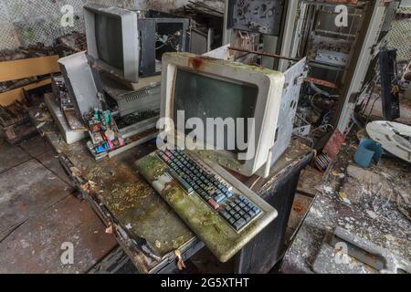 Old computers from the 80s in an abandoned computing center Stock Photo