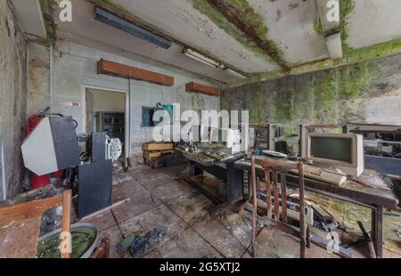 Old computers from the 80s in an abandoned computing center Stock Photo