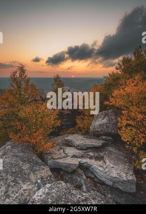 A rocky cliff with trees and a sunset in the background, Cragsmoor, Shawangunk Mountains, New York Stock Photo