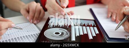 Discussion of financial and commercial indicators on tablet Stock Photo