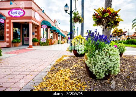 Venice, USA - April 29, 2018: Small Florida city town in gulf of Mexico coast with garden plants flowers by sidewalk road street and nobody Stock Photo