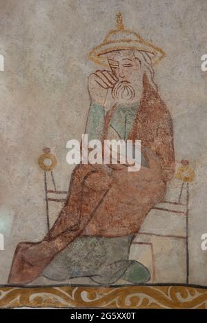 Saint Joseph, the husband of Mary, in a jewish hat, sitting in a chair, an ancient mural in Skibby church in Denmark, June 28, 2021 Stock Photo