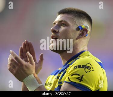 Danny Walker (16) of Warrington Wolves applauds the travelling supporters at the end of the game after beating Wigan Warriors 14-40 Stock Photo