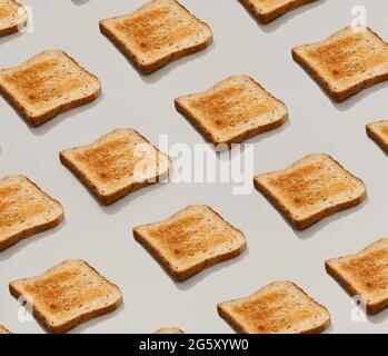 Pattern with fresh toasted bread on gray background flat lay top view Stock Photo