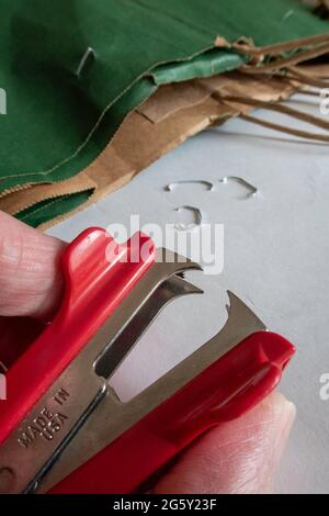 Close up of a Man Using a Stapler Remover, USA Stock Photo