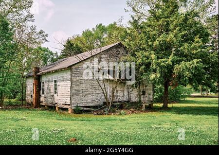 Rustic vintage wooden one room school house or small church sitting abandoned in Alabama, USA. Stock Photo