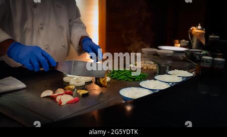 A chef prepares a healthy gourmet meal with vegetables in the Minato suburb of Tokyo, Japan. Stock Photo