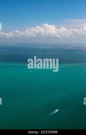 Aerial view of a boat driving across the ocean near Key West, Florida. Stock Photo