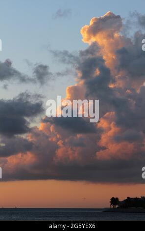 Large clouds show the hues of a Key West sunset. Stock Photo