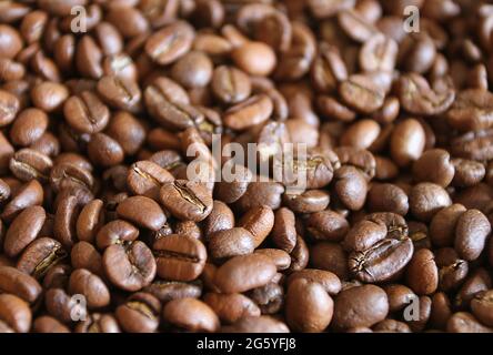 A pile of whole coffee beans close up. Stock Photo
