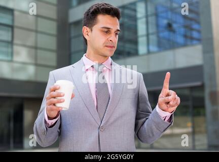 Businessman touching imaginary screen Stock Photo