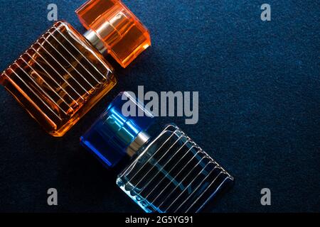 Glass orange bottle and a blue bottle lotion on a blue surface Stock Photo