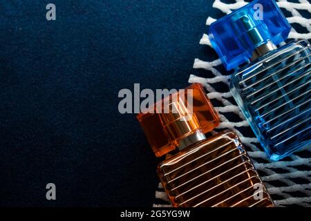 Glass orange bottle and a blue bottle lotion on a blue surface Stock Photo