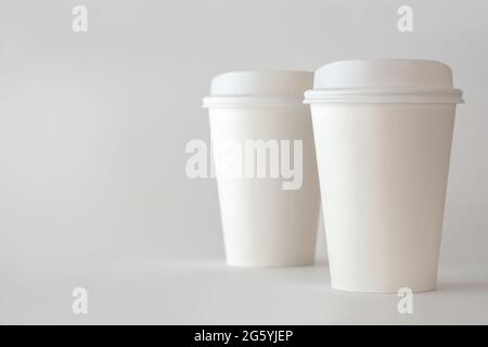 Two White Paper Coffee Cups on White background, Coffee Cup Mockup. Stock Photo