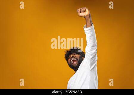Portrait of overjoyed black man celebrating success Stock Photo