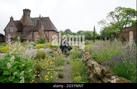 Lead gardener Saffron Prentis in the new Delos garden at the National Trust's Sissinghurst Castle in Cranbrook, Kent. Created in partnership with gardener Dan Pearson the garden uses innovative techniques to harvest maximum sunlight and Mediterranean plants to bring a slice of Greece to the Grade I-listed garden in rural Kent. Picture date: Tuesday June 29, 2021. Stock Photo