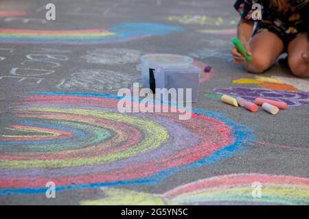 Chalks in rainbow colors. Chalk for drawing on the school board and on the street on the pavement. Children's toy is entertainment. Baby crayons box - multicolor chalk Stock Photo