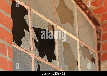Close up of muntin window with broken glass of old abandoned building Stock Photo