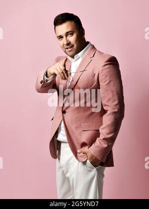 Young dark-haired businessman, entrepreneur in modern stylish suit stands pointing with finger at camera Stock Photo