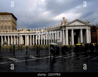 Rome, Italy - March 8 2016 - Piazza San Pietro in the rain. People are searching for shelter. Stock Photo