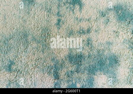 Blue green spoted exposed wall texture.Empty old stained art texture of plaster brick wall background. Stock Photo