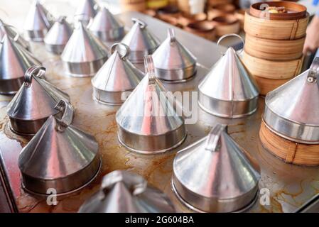 Bamboo container and stainless steel lid for steam food in dim sum restaurant. Stock Photo