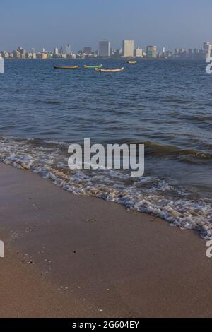 Waves and beach and the skyline of Nariman point at Mumbai as seen from marine drive beach at Mumbai India on 2 April 2021 Stock Photo