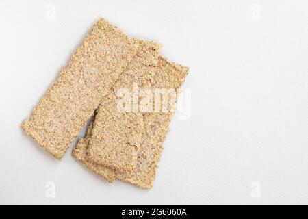 light brown multigrain rye crispbreads isolated on white background, bread cracker snacks, top view Stock Photo