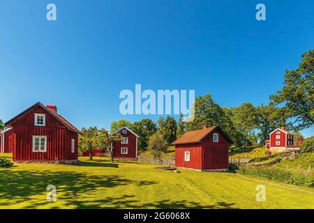 Historic village with ancient red wooden houses in Sweden Stock Photo