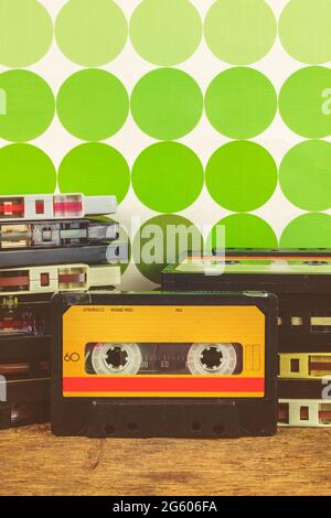 Retro styled image of vintage audio compact cassettes on a wooden table Stock Photo