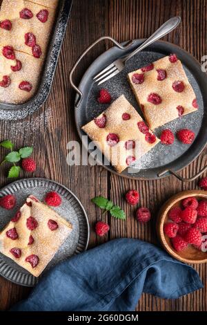 Fruity raspberry cake known as Bublanina sprinkled with powdered sugar Stock Photo