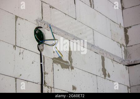 electrical wiring of the house, cable on the wall in the gate. Selective focus Stock Photo