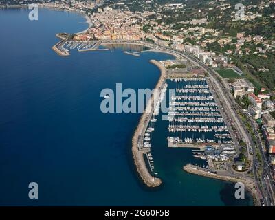 AERIAL VIEW. Marina of Menton Garavan with the picturesque Old Town of Menton in the distance. French Riviera, Alpes-Maritimes, France. Stock Photo