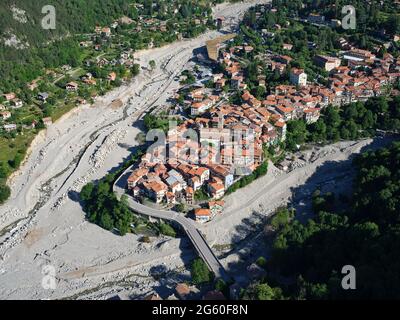 AERIAL VIEW. Medieval town of Saint-Martin-Vésubie at the confluence of the Boréon & the Vésubie Rivers. Vésubie Valley, Alpes-Maritimes, France. Stock Photo