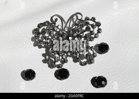 vintage brooch in shape of  the gray butterfly decorated shine crystal beads Stock Photo