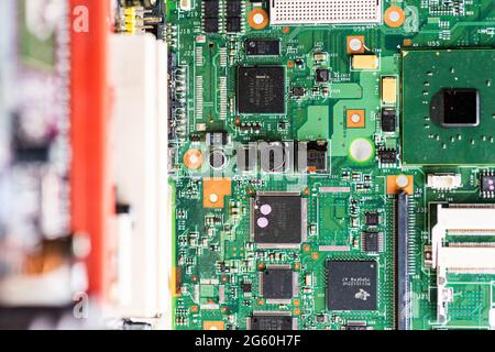 Close up image of circuit boards taken from old PC desk top computers. The image shows electronic components soldered onto coloured cuircuit boards. Stock Photo