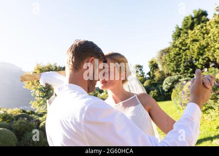 Happy caucasian bride and groom getting married and dancing Stock Photo