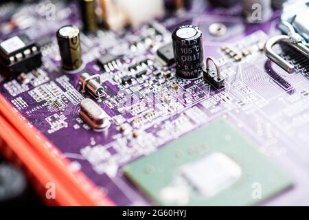 Close up image of circuit boards taken from old PC desk top computers. The image shows electronic components soldered onto coloured cuircuit boards. Stock Photo