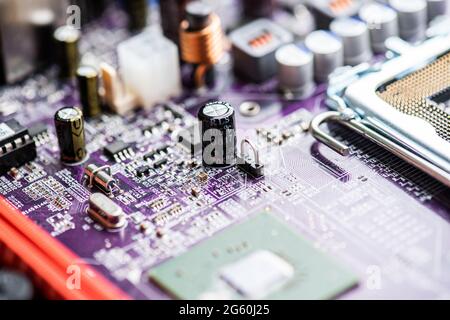 Close up image of circuit boards taken from old PC desk top computers. The image shows electronic components soldered onto coloured cuircuit boards. Stock Photo