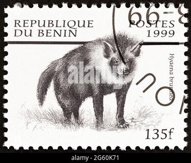 BENIN - CIRCA 1999: A stamp printed in Benin from the 'Mammals' issue shows Brown hyena (Hyaena brunnea), circa 1999. Stock Photo