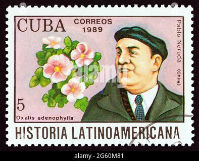 CUBA - CIRCA 1989: A stamp printed in Cuba from the 'Latin American History' issue shows Pablo Neruda and Oxalis adenophylla (Chile). Stock Photo