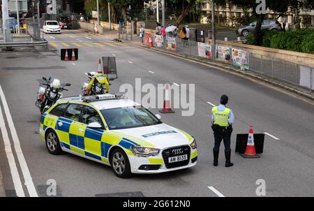 Hong Kong, Hong Kong, China. 1st July, 2021. Hong Kong police create road blocks in parts of Hong Kong on the 24th anniversary of the Handover of Hong Kong to China from Britain in 1997.It coincides with the 100th Anniversary of the Communist party in China. Many people were expected to show up at the traditional protest site of Victoria Park but Police closed the area to prevent gatherings as no protest was authorized. Credit: Jayne Russell/ZUMA Wire/Alamy Live News Stock Photo