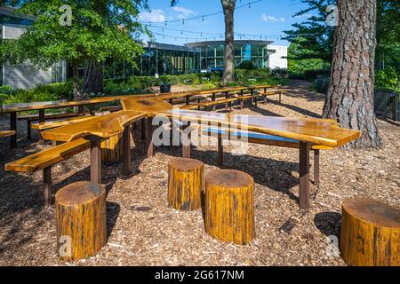 Repurposed tree table, a 60 foot long work of art, made from a fallen oak tree on the grounds of the Atlanta History Center in Buckhead, Atlanta, GA. Stock Photo