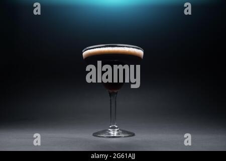 Martini in a fancy glass with blue game dice Stock Photo - Alamy