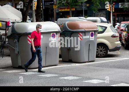 Man wearing afce mask crossing the street, Barcelona. Stock Photo