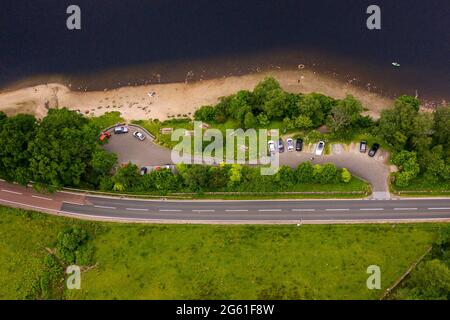 Loch Lubnaig, Loch Lomonnd and Trossachs National Park, Scotland, UK. 1st July, 2021. PICTURED: Drone aerial view looking down from above of Loch Lubnaig showing the low water levels which have exposed stone beaches all along the perimeter of the loch side, which would otherwise be under dark peaty water. Credit: Colin Fisher/Alamy Live News Stock Photo